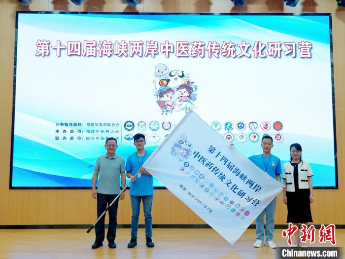 共青團福建省委副書記吳雪(右一)、福建中醫(yī)藥大學黨委副書記林羽(左一)為兩岸學生代表頒授營旗?！≡S燁婷 攝