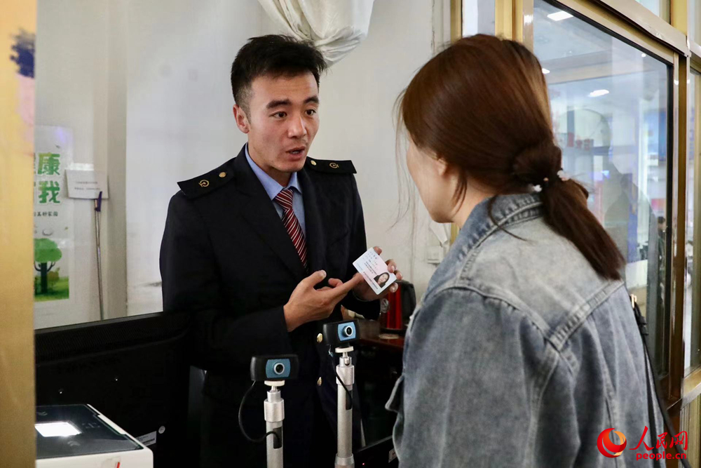 車站工作人員向旅客解答疑問(wèn)。人民網(wǎng)記者 次仁羅布攝